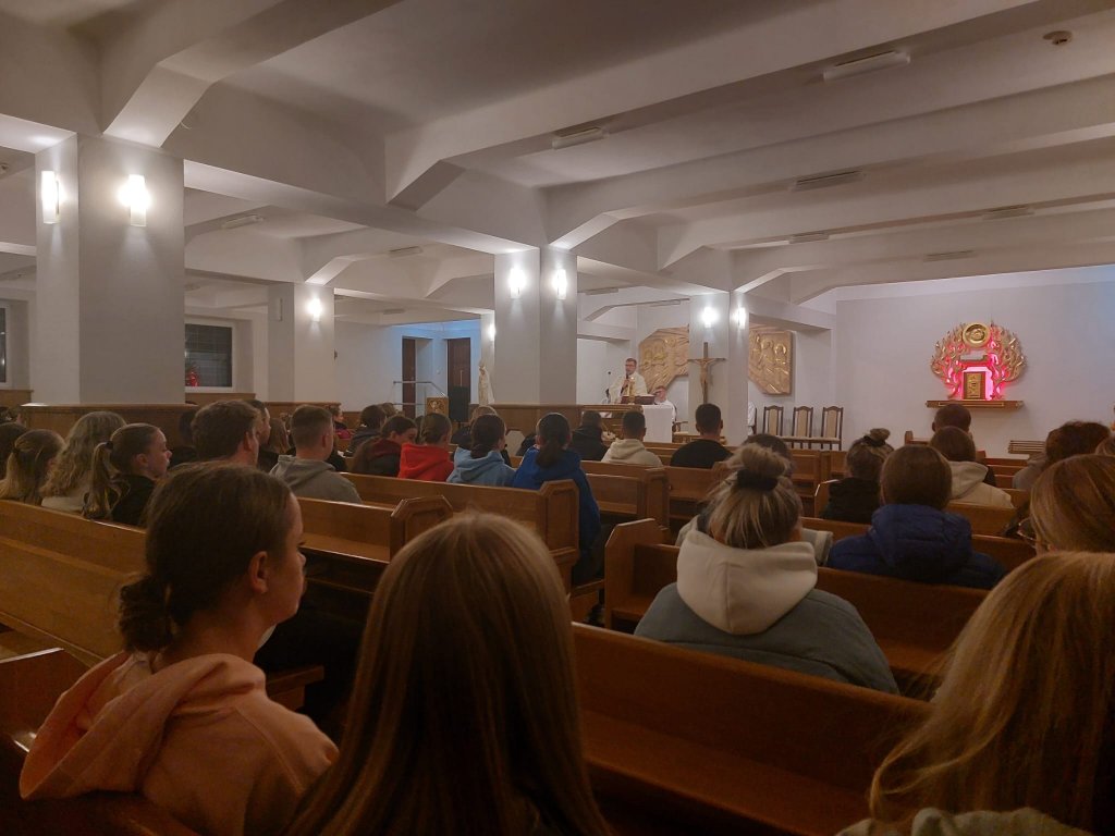 Zdjęcie przedstawiające młodzież i księdza Karola Sosnowskiego podczas Mszy świętej w kaplicy